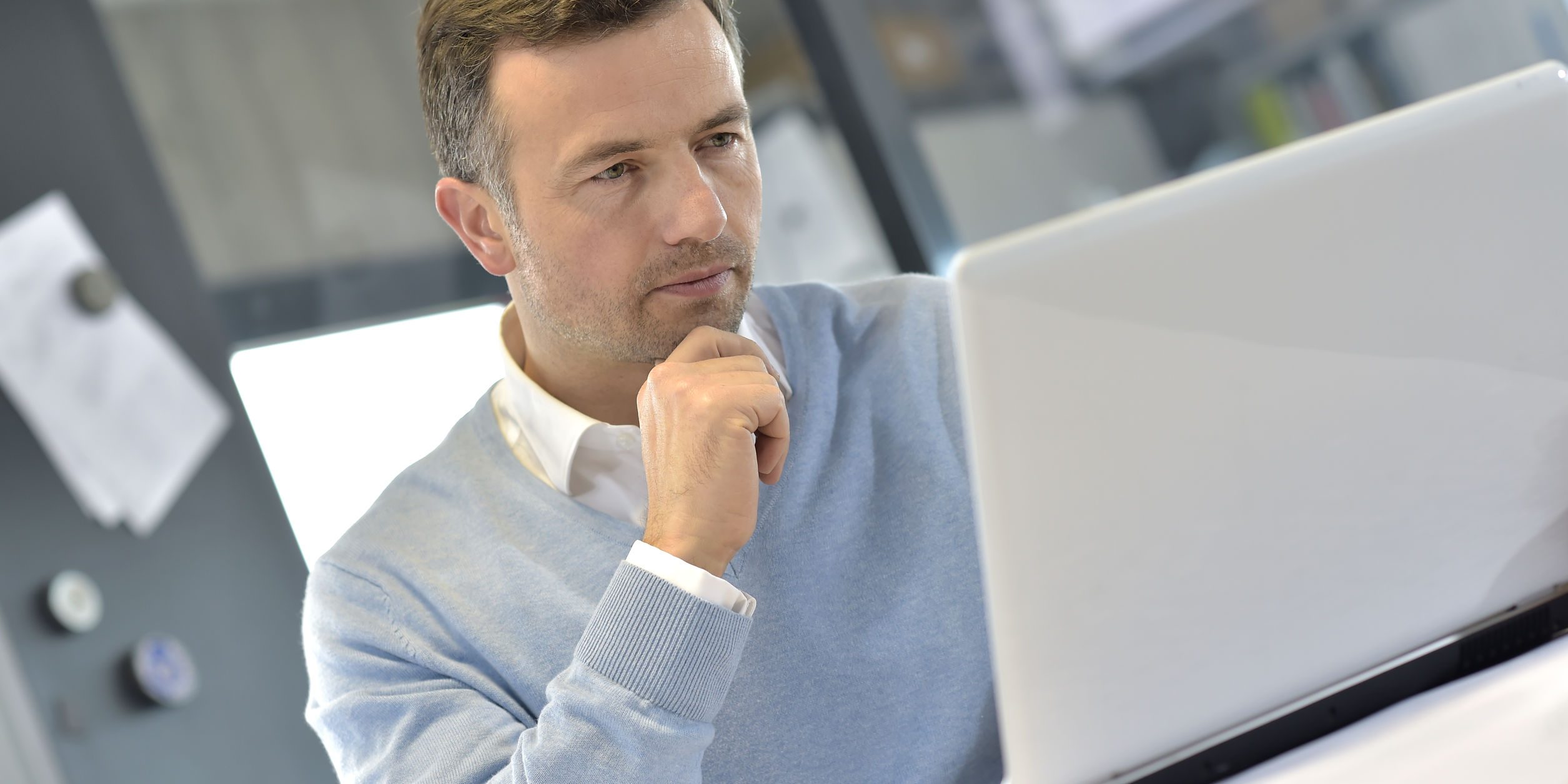 Industrial manager in office working on laptop
