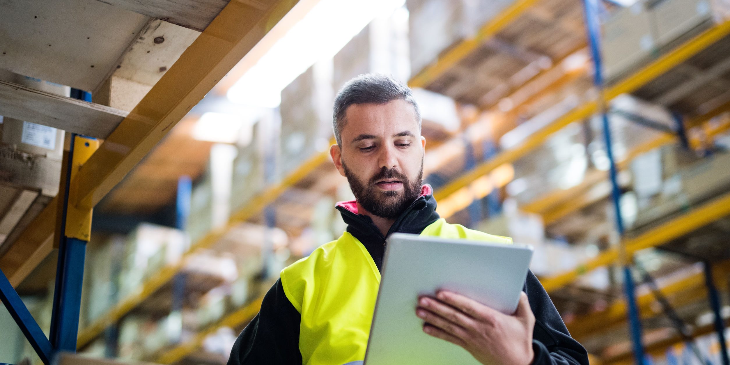 Male warehouse worker with tablet.