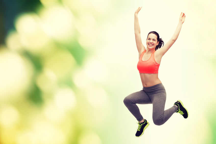 sporty teenage girl jumping in sportswear