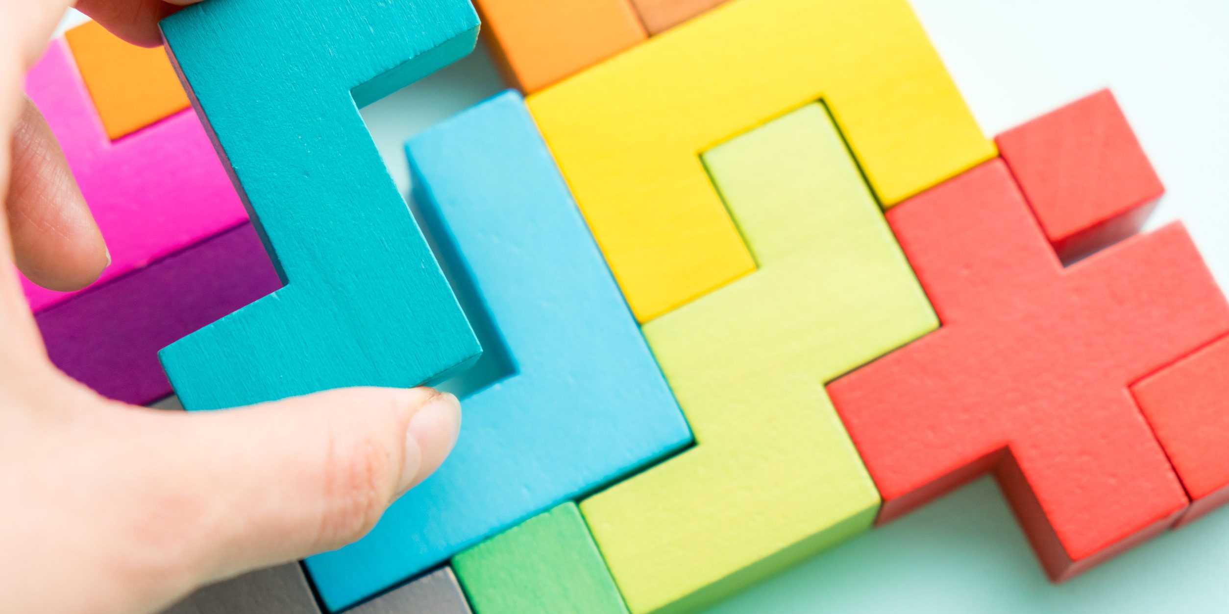 Puzzle on boards team business concept. IQ test. Choose correct answer. Logical tasks composed of colorful wooden shapes, top view. Children’s educational logical task, flat lay. Visual conundrum.