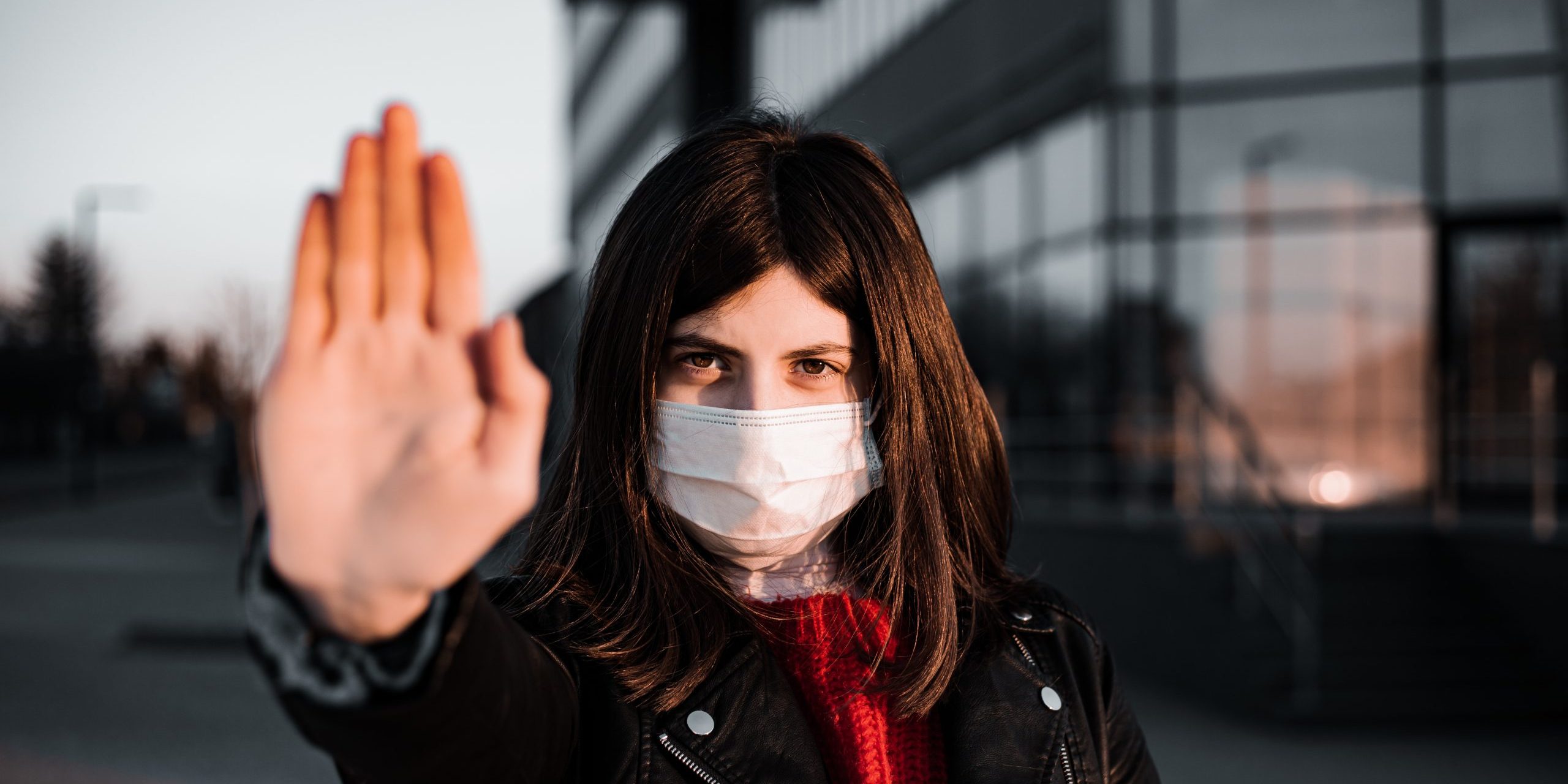 Young girl shows hand sign stop no to coronavirus epidemic pandemia originated at China. Covid-19 virus, nCov2019. Girl is against using public transport and stay home during quarantine.
