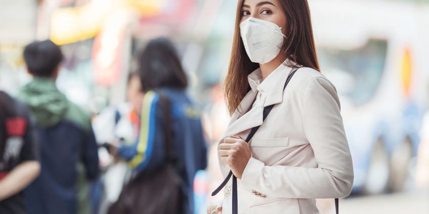 Asian woman are going to work.she wears N95 mask.prevent PM2.5 d
