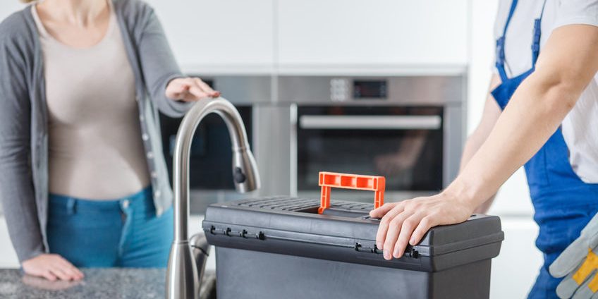 Sanitation technician with black toolbox