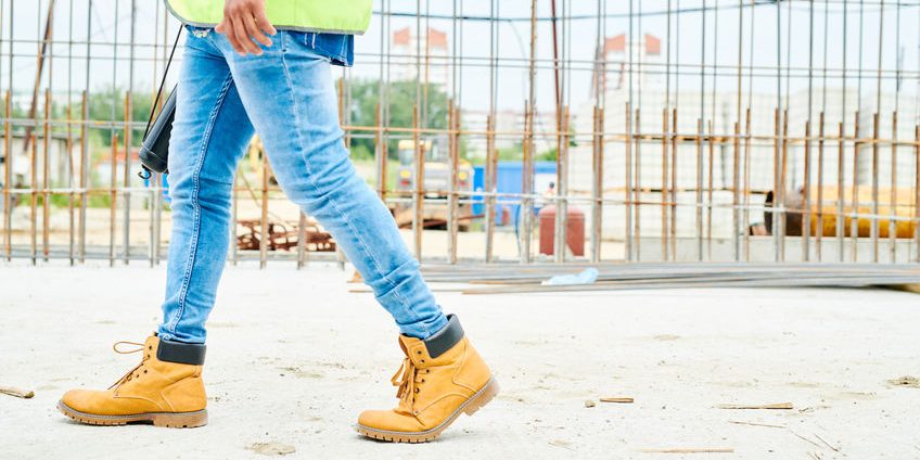 Unrecognizable Worker walking on Site