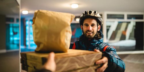 Pizza,Delivery,Home.,The,Courier,With,The,Bicycle,Helmet,Delivers