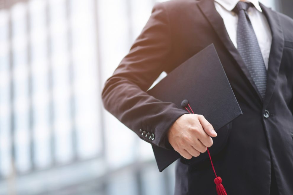 Graduates,Of,The,University,,Businessman,Holding,Hats,Along,With,Success,