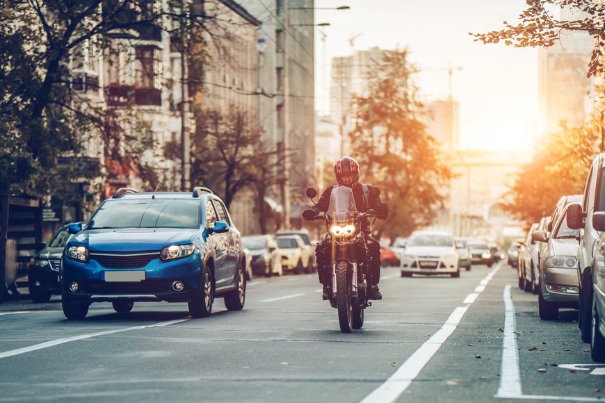 Motorcycle,And,Cars,Are,Riding,On,Street.,City,During,The